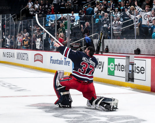 Connor Hellebuyck one knee win celebration Winnipeg Jets canvas wall art