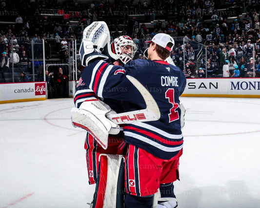 Connor Hellebuyck and Eric Comrie victory hug Winnipeg Jets canvas wall art