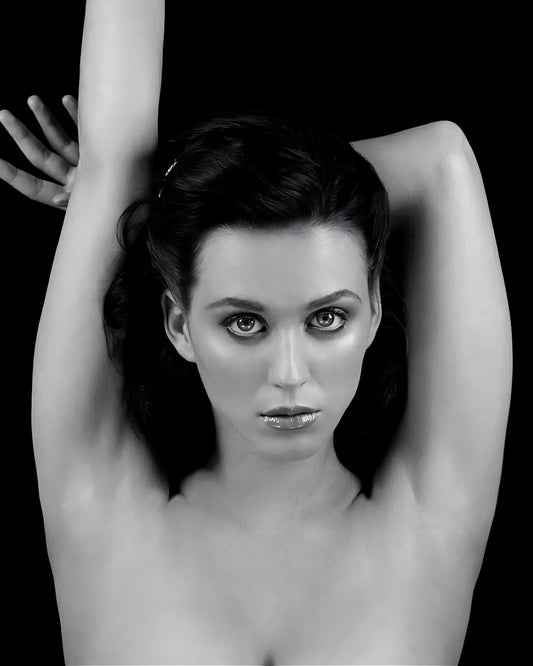 Katy Perry Black and white portrait of a woman with her arms raised against a black background