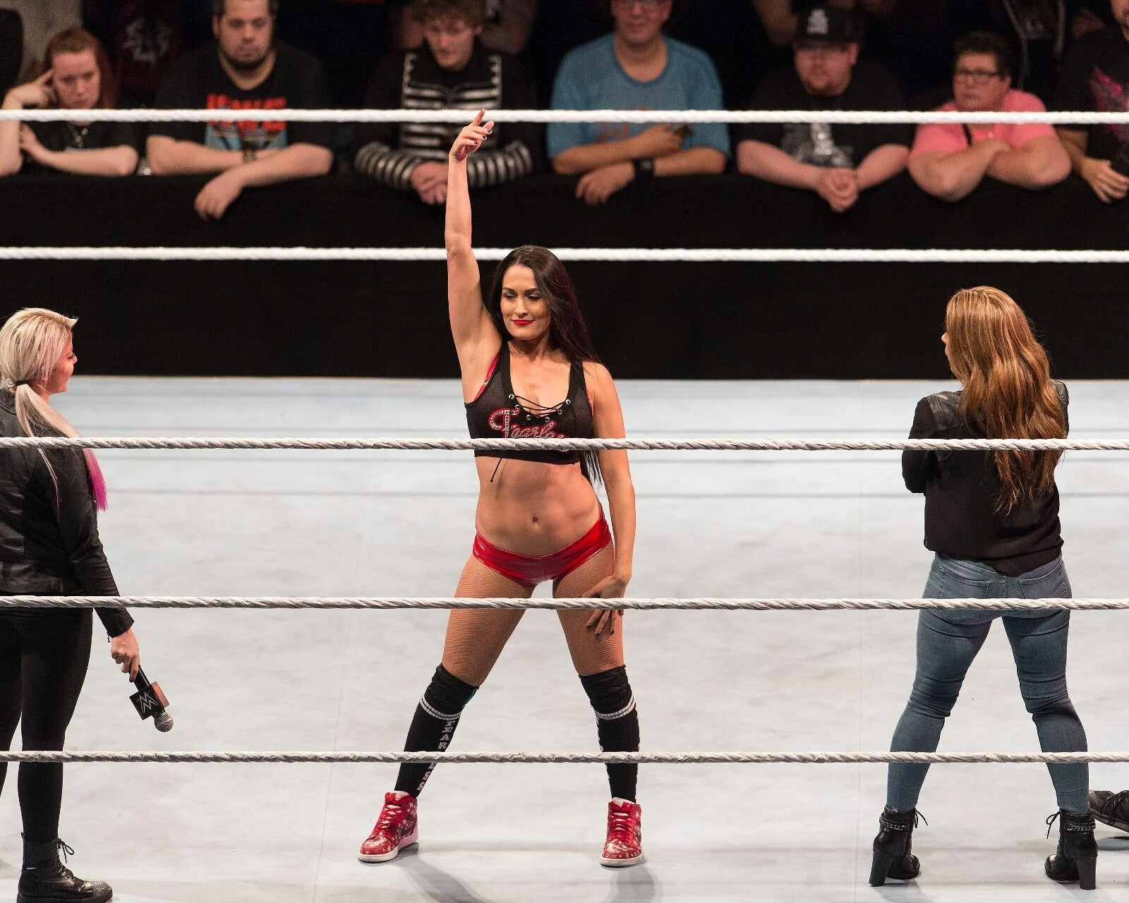 Nikki Bella holding championship belt in the ring canvas wall art