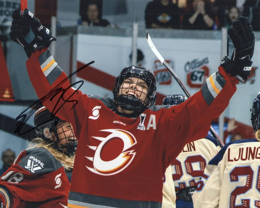 An autographed 8x10 photograph of hockey player Cam Tacke in a red Calgary Flames jersey, celebrating with her arms raised in the arena.