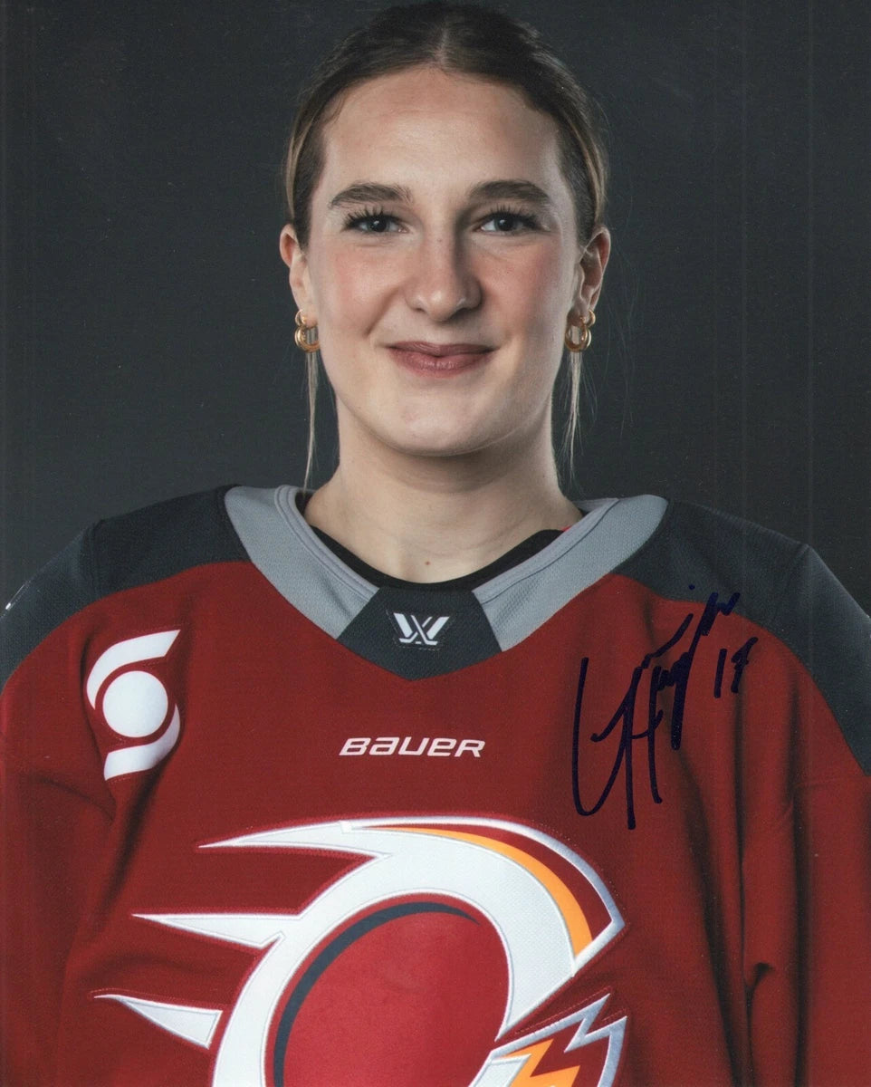 An autographed portrait of a woman wearing a red and gray Calgary Flames hockey jersey by Bauer, with a dark gray background.
